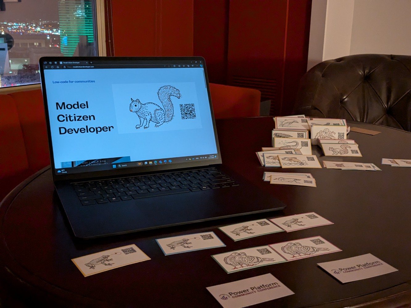 A computer on a table with several cards on it Description
automatically generated