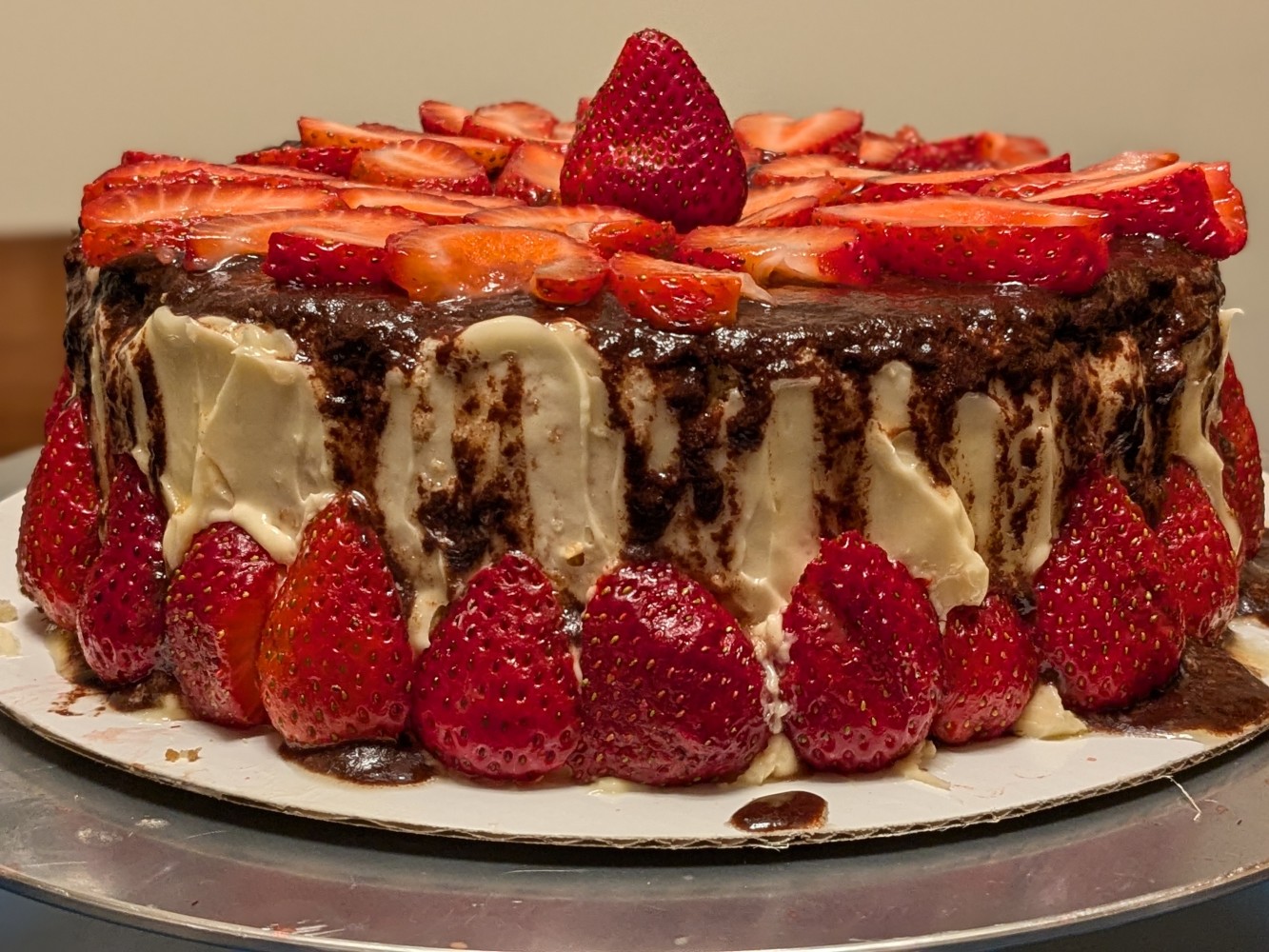 A cake with strawberries on top Description automatically
generated