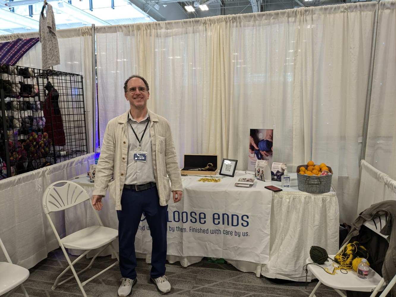 A person standing in front of a table with white curtains Description
automatically generated